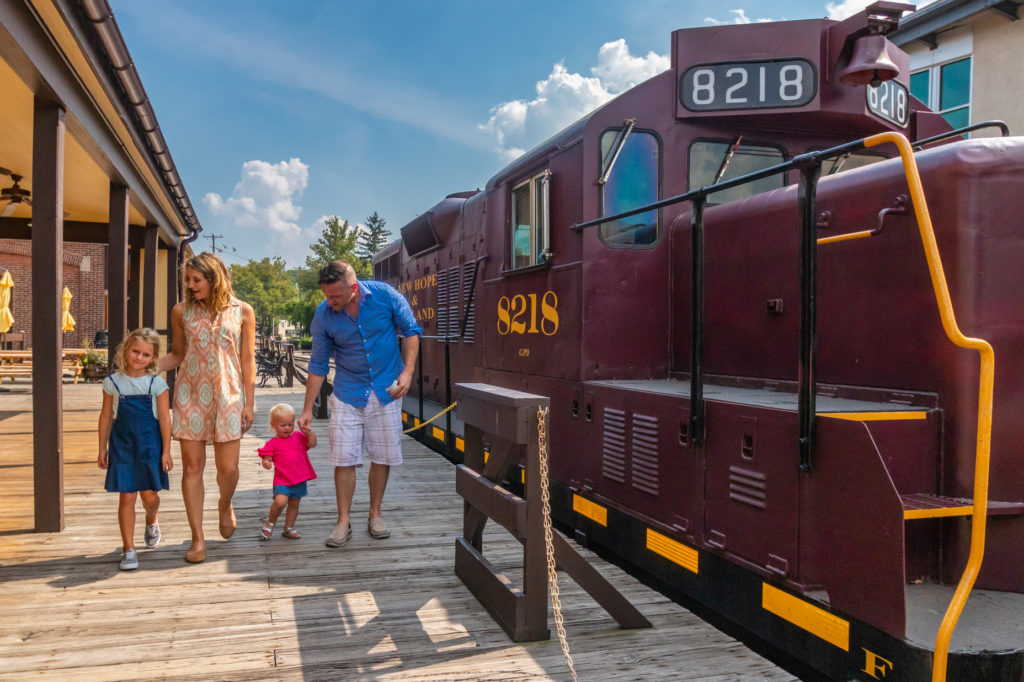 A photo of a family outside a New Hope Railroad train car