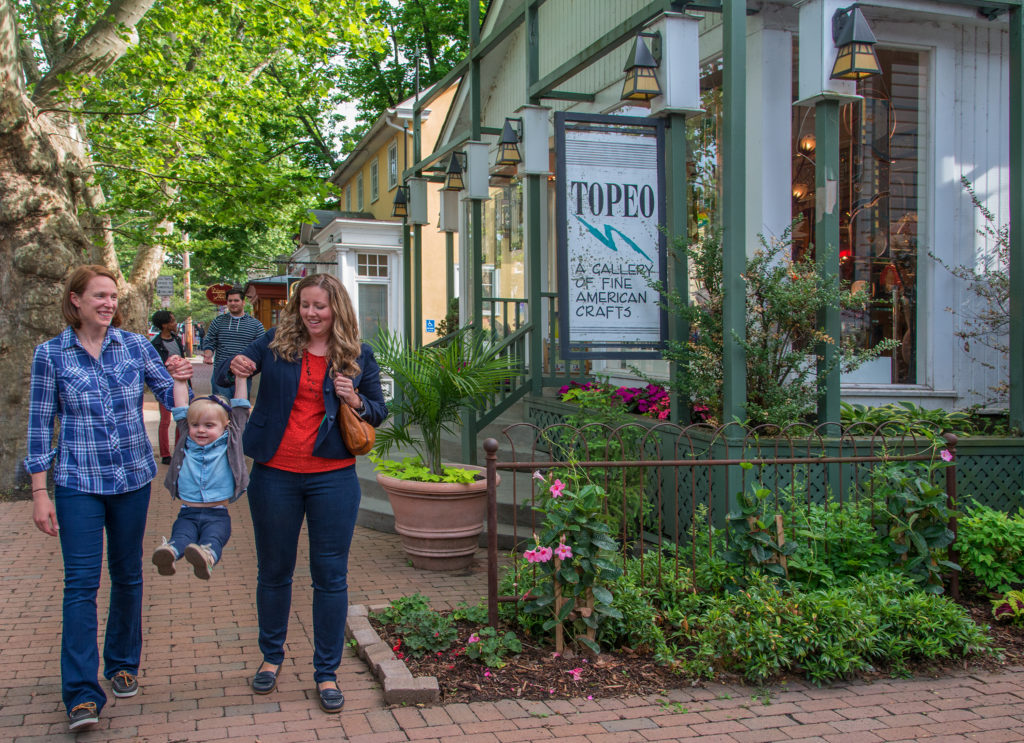 A family walks down the quaint streets of new hope. 