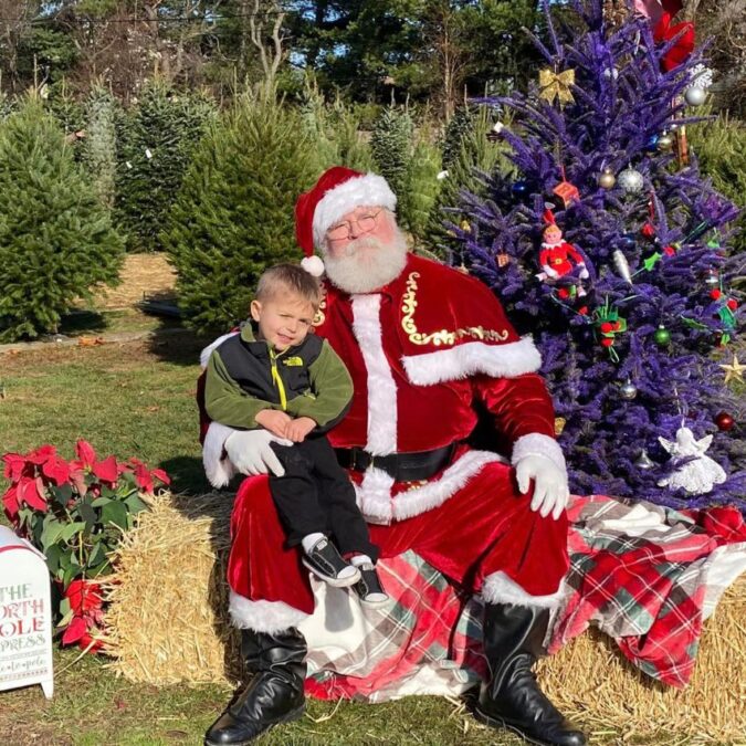 Santa and a little boy pose for a picture at Charlann Farms in Bucks County.