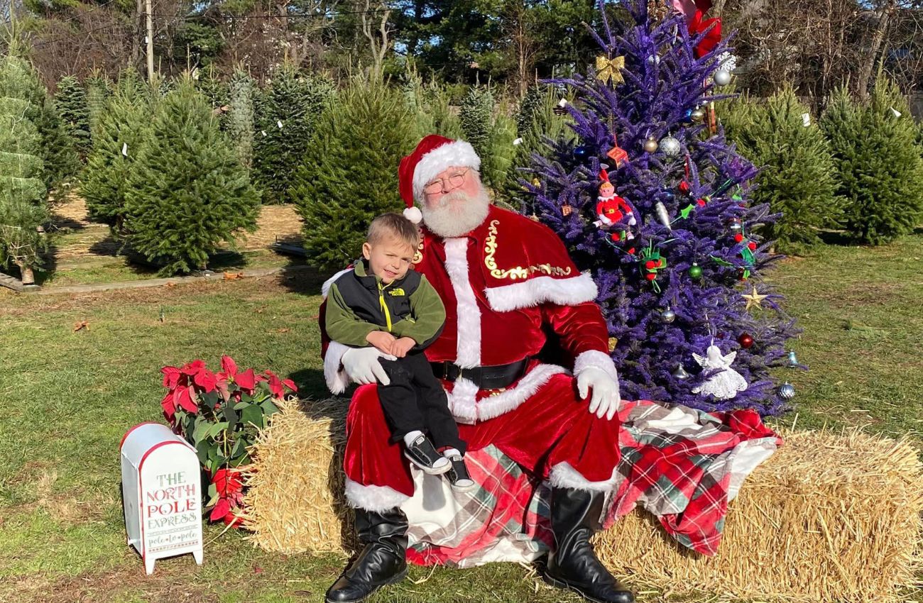 Santa and a little boy pose for a picture at Charlann Farms in Bucks County.