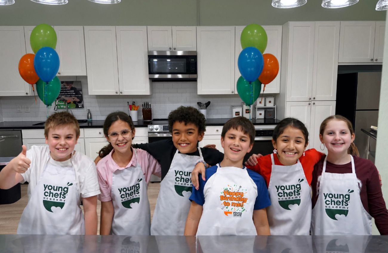 Six kids in apron pose at a birthday party at Young Chefs Academy Yardley.