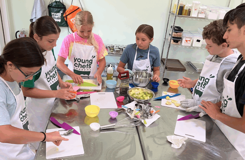 A group of boys and girls chop ingredients at Young Chef's Academy of Yardley. 