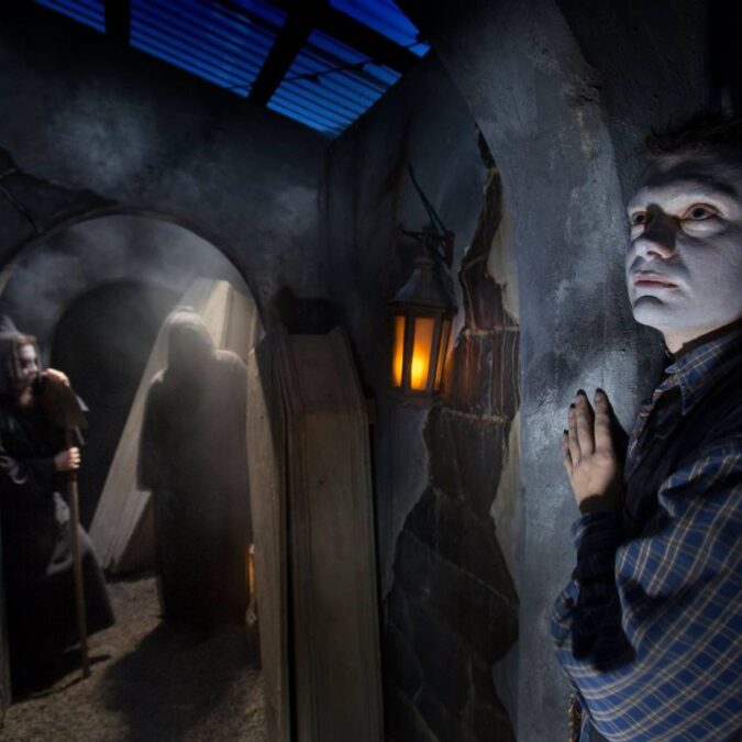 A white-faced ghoul stands at a spooky doorway at Sleepy Hollow Haunted Acres attraction in Newtown, PA.
