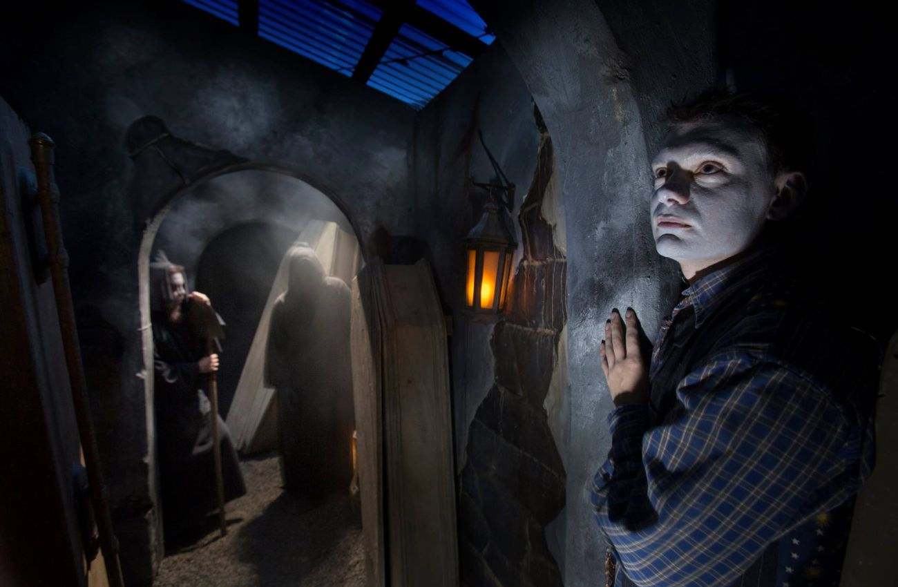 A white-faced ghoul stands at a spooky doorway at Sleepy Hollow Haunted Acres attraction in Newtown, PA.
