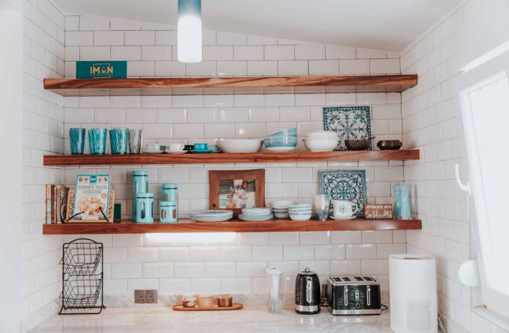 A wall with open shelving that displays unique kitchenware. It's simple upgrade that adds character to a room.