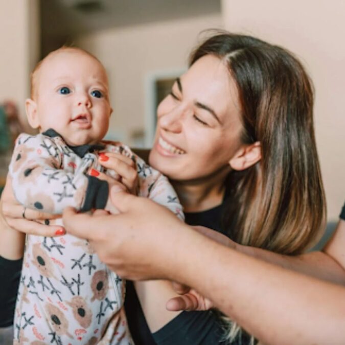 A new mom and dad hold their newborn baby, courtesy of Breastfeeding Resource Center in Bucks County, PA.