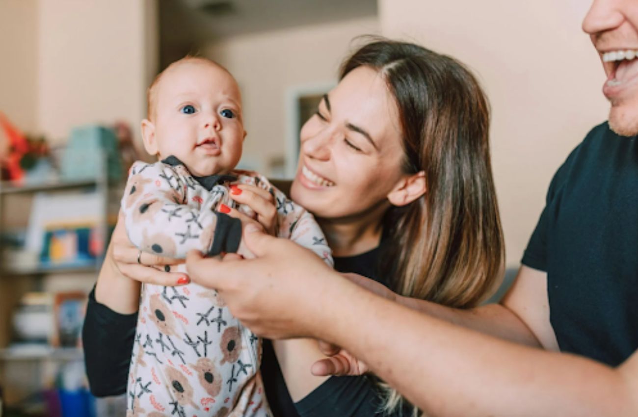 A new mom and dad hold their newborn baby, courtesy of Breastfeeding Resource Center in Bucks County, PA.
