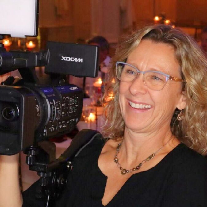 Videographer Kari Ries holds her camera.