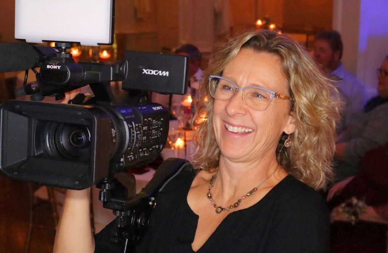 Videographer Kari Ries holds her camera.