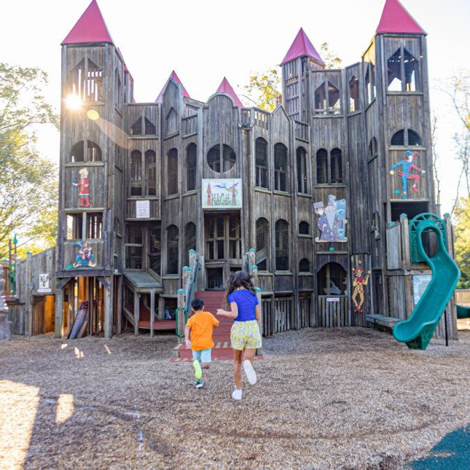 Two children explore Kids Castle playground in Doylestown, PA