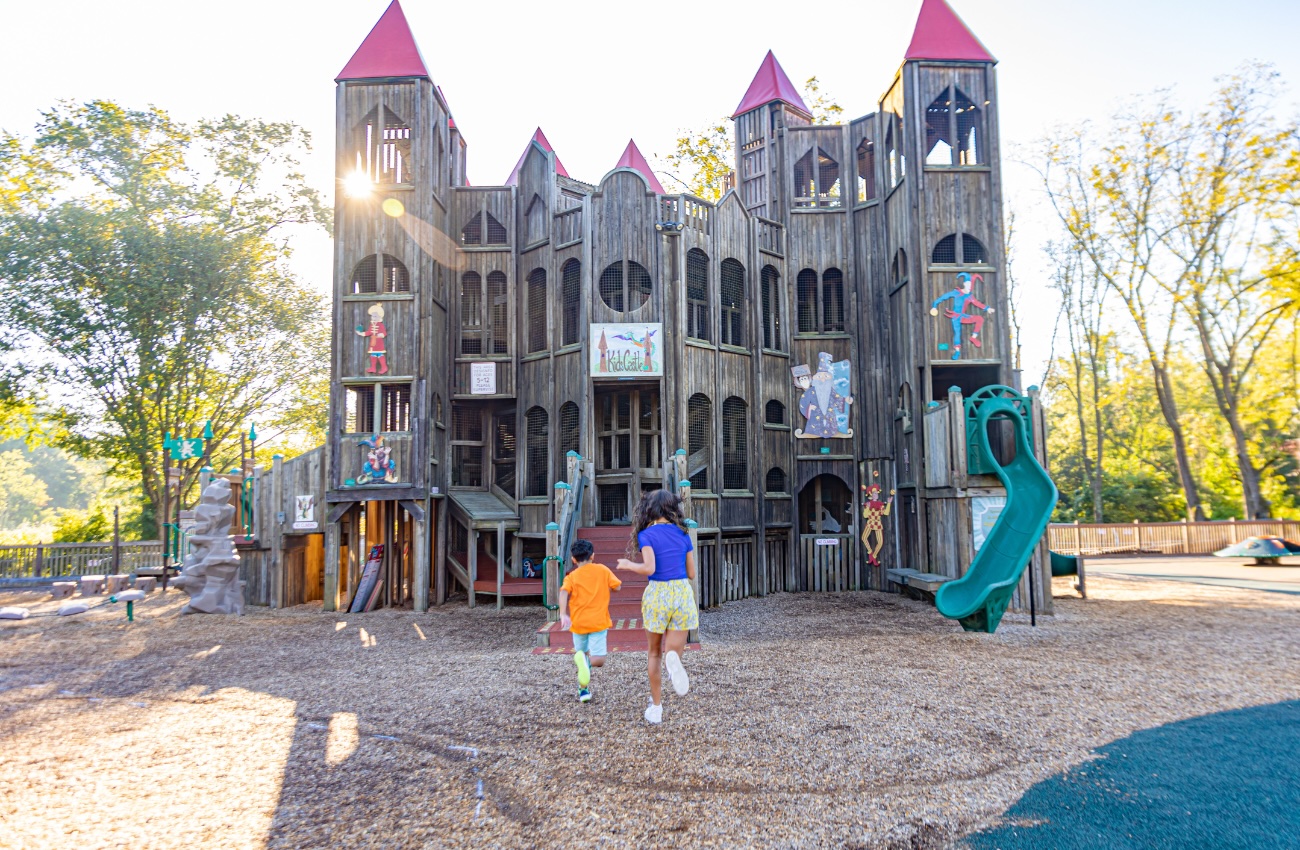 Two children explore Kids Castle playground in Doylestown, PA