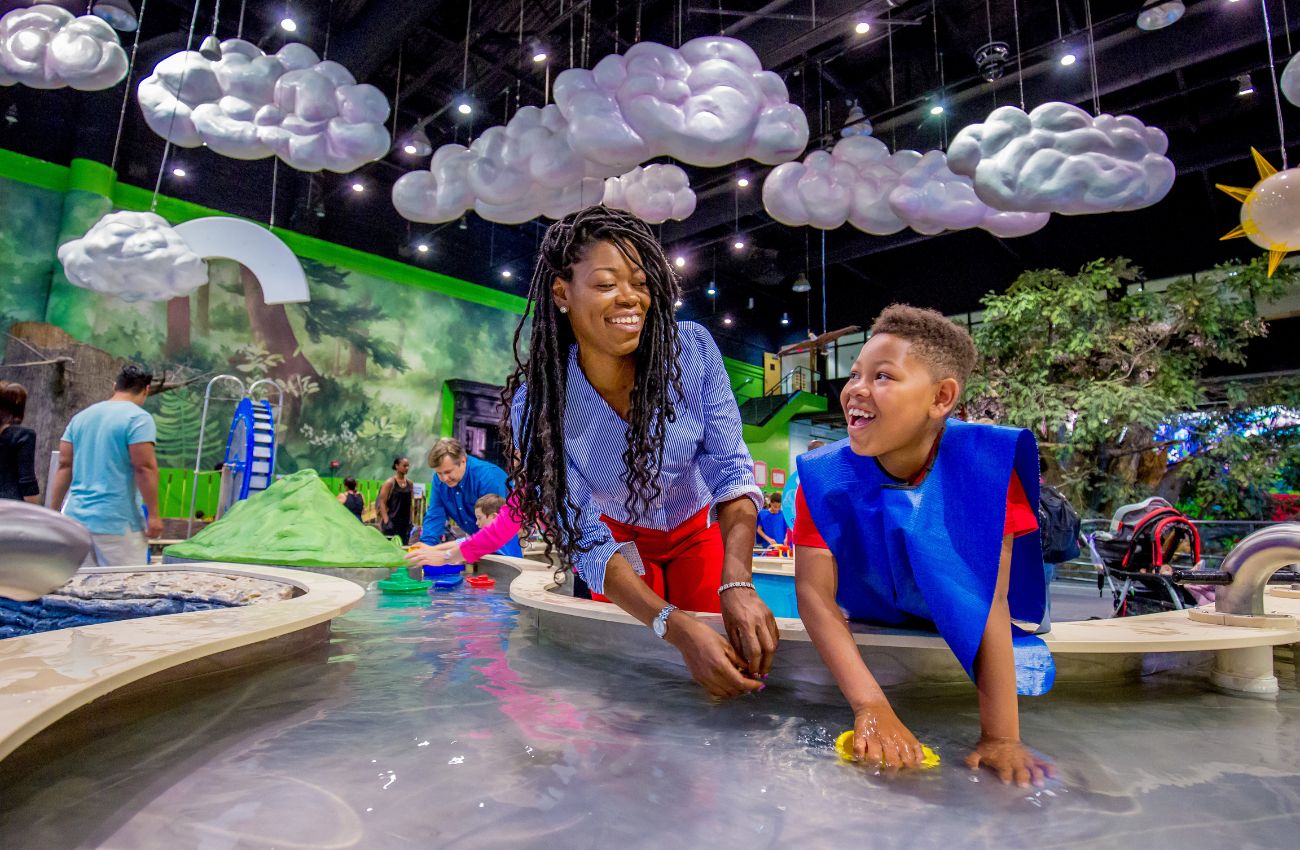 Mother and son play at a water table at the Please Touch Museum in Philadelphia