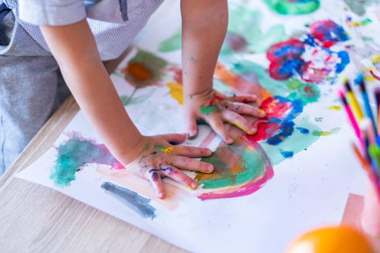 Child's hands playing with paint